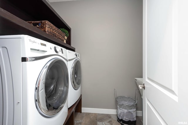 washroom featuring baseboards, laundry area, and washer and dryer