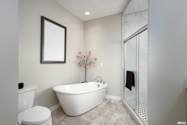 bathroom featuring baseboards, toilet, a freestanding tub, a shower stall, and recessed lighting