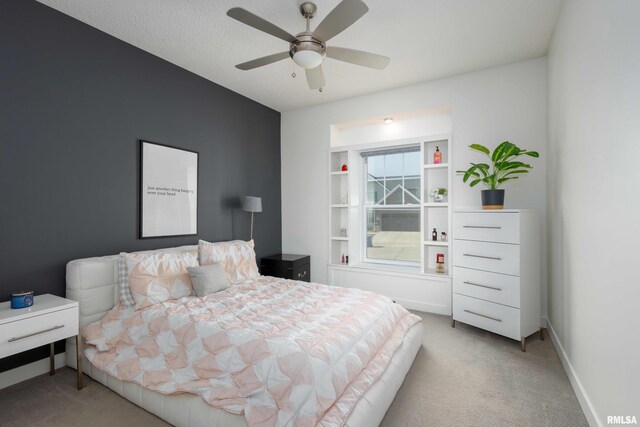 bedroom featuring baseboards, ceiling fan, and light colored carpet