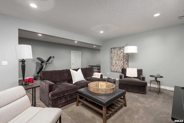 living room featuring light carpet, a textured ceiling, baseboards, and recessed lighting