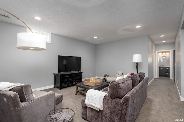 living room with recessed lighting, light carpet, visible vents, and baseboards