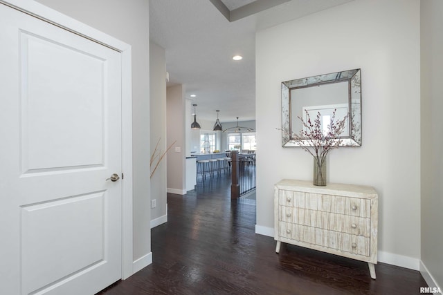 corridor with baseboards, dark wood-type flooring, and recessed lighting