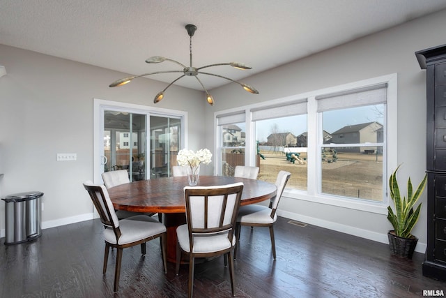 dining area with visible vents, baseboards, dark wood finished floors, and a textured ceiling