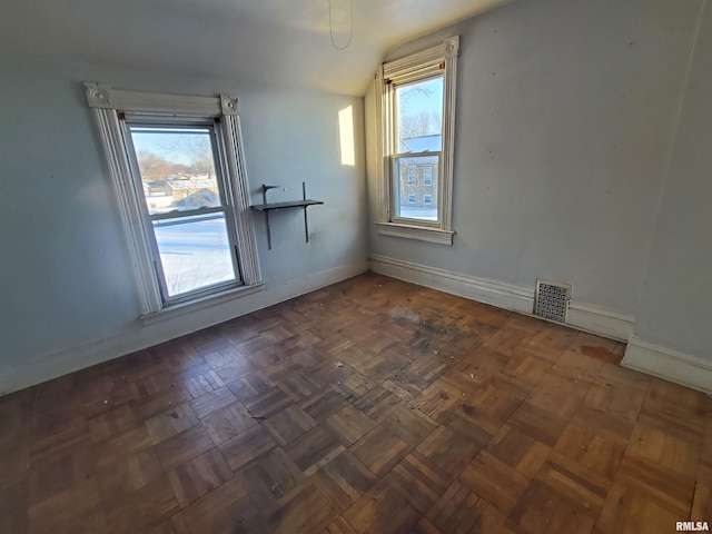 empty room with visible vents and baseboards