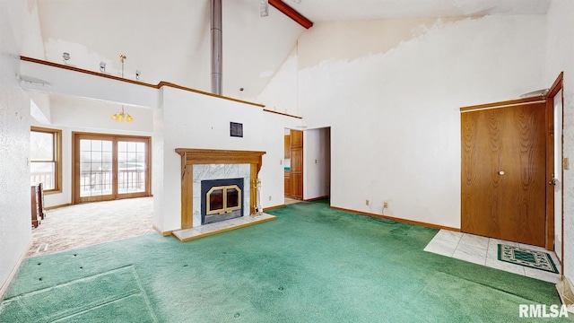 unfurnished living room with beam ceiling, a premium fireplace, carpet flooring, high vaulted ceiling, and baseboards