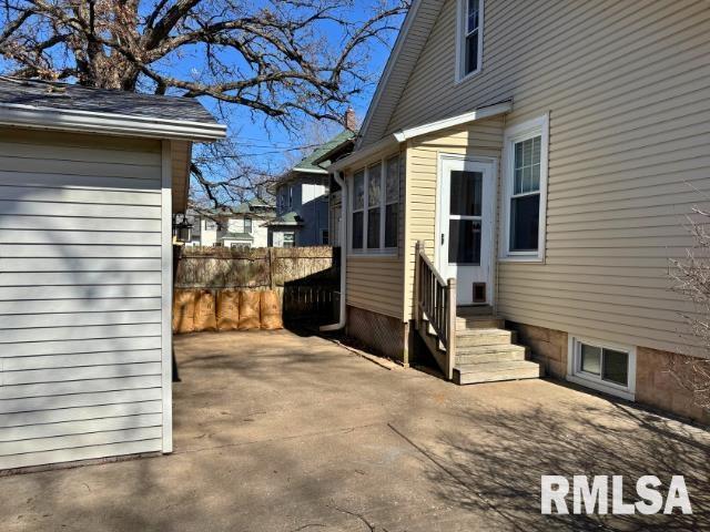 view of home's exterior with entry steps and fence