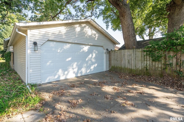 detached garage featuring fence
