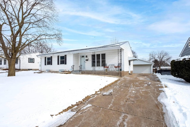 view of front of home featuring an outbuilding, covered porch, and a garage