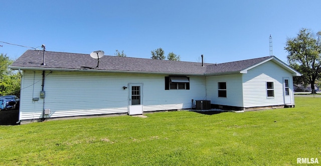 223 N King St, Hurst, IL 62949 - rear view of house with a yard, roof with shingles, and central AC