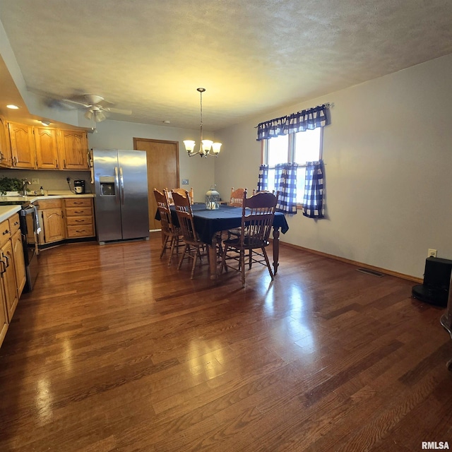 223 N King St, Hurst, IL 62949 - dining room featuring a chandelier, dark wood-style floors, ceiling fan, and baseboards