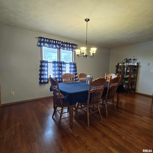 223 N King St, Hurst, IL 62949 - dining area featuring wood finished floors, a chandelier, and baseboards