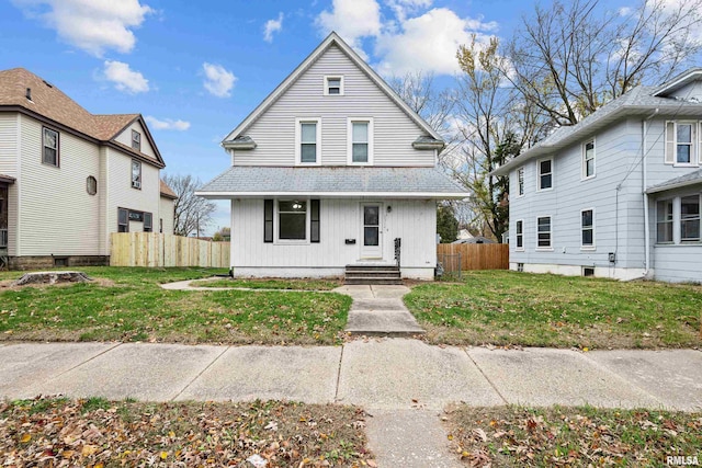 view of front of house featuring a front yard and fence