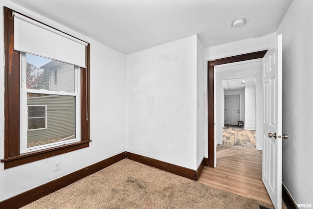 spare room with light wood-style floors and baseboards