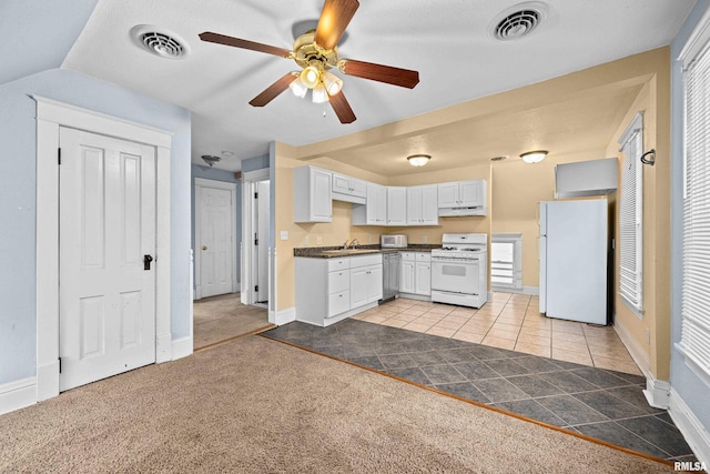 kitchen featuring white appliances, visible vents, white cabinets, dark countertops, and under cabinet range hood