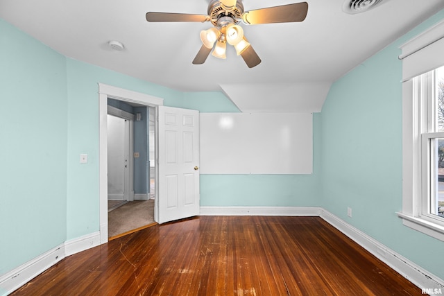 unfurnished bedroom with ceiling fan, wood finished floors, visible vents, and baseboards