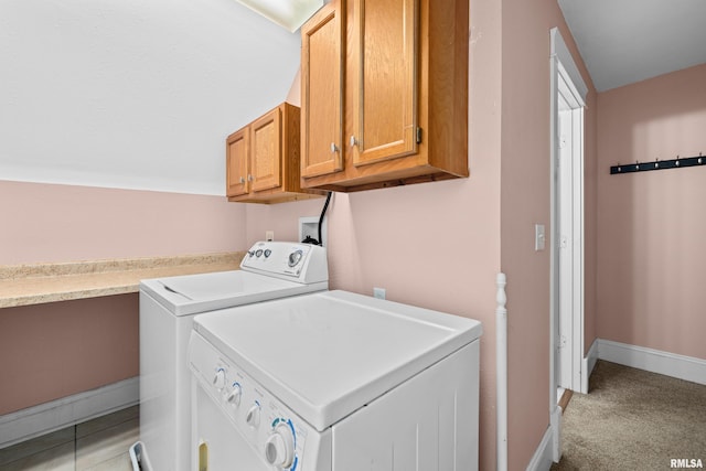 washroom featuring light carpet, cabinet space, washer and clothes dryer, and baseboards