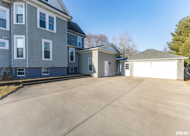 view of side of home featuring a detached garage