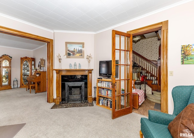 carpeted living area featuring stairway, a premium fireplace, and ornamental molding