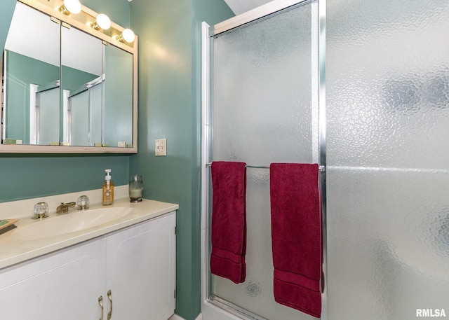full bath featuring vanity and a shower stall