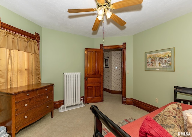 bedroom with radiator, ceiling fan, light carpet, and baseboards