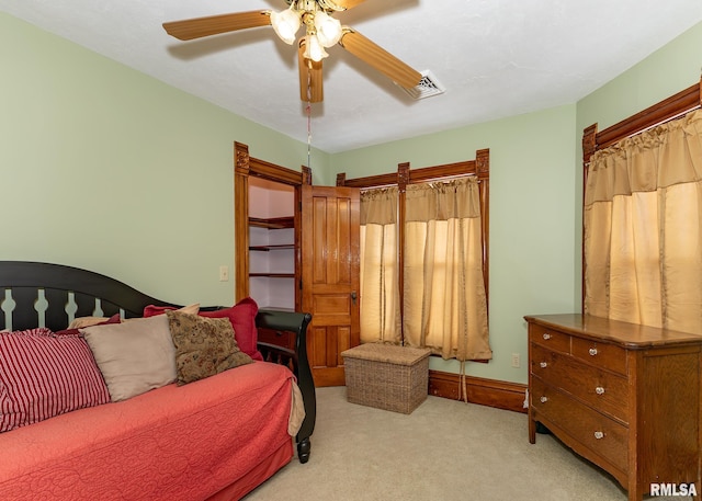 bedroom with light colored carpet, visible vents, and a ceiling fan