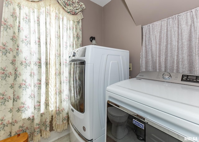 washroom with washing machine and clothes dryer and laundry area
