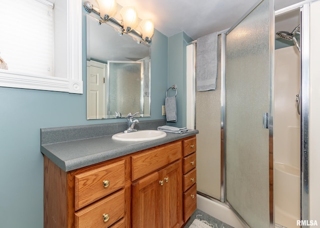 bathroom with a stall shower and vanity