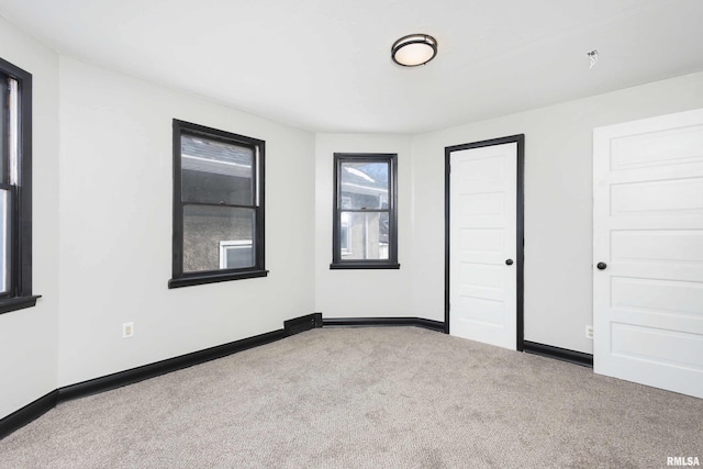 empty room with carpet floors and baseboards