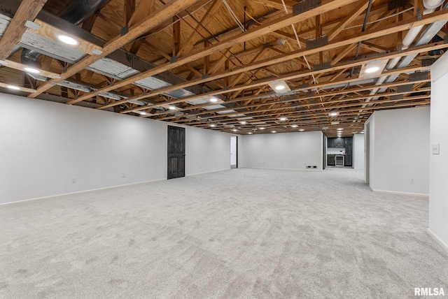 below grade area featuring carpet floors and baseboards