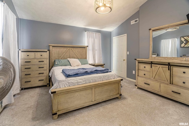 bedroom with light carpet, lofted ceiling, visible vents, and baseboards