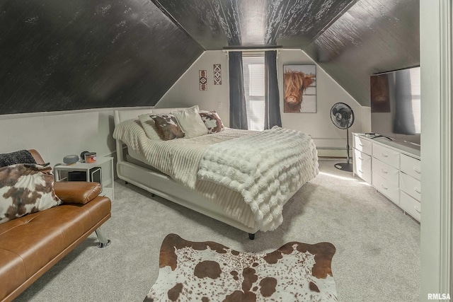 bedroom with lofted ceiling, a baseboard heating unit, and light colored carpet