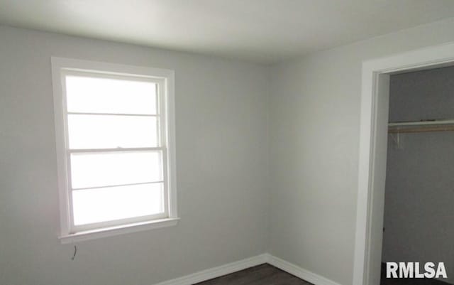 unfurnished bedroom featuring a closet and baseboards