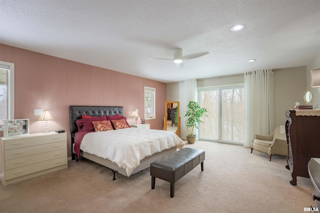 bedroom featuring light carpet, a textured ceiling, a ceiling fan, and access to exterior