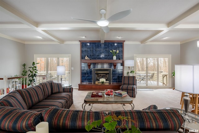 living room featuring beam ceiling, carpet flooring, and a wealth of natural light