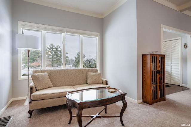 carpeted living area with baseboards, visible vents, and crown molding