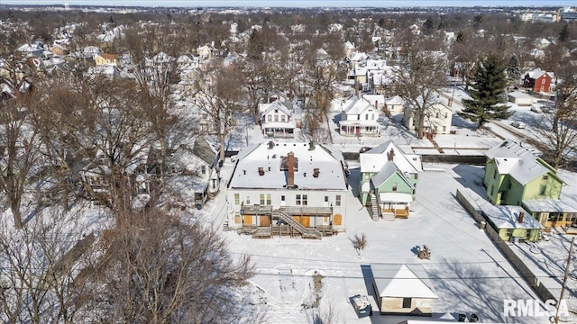 snowy aerial view with a residential view