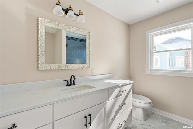 bathroom with toilet, marble finish floor, vanity, and baseboards