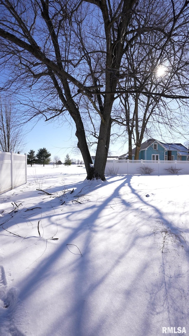 yard covered in snow with fence