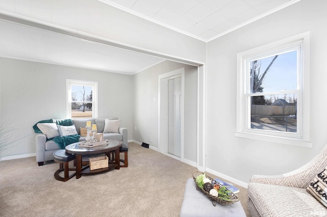 living area with light colored carpet, crown molding, and baseboards