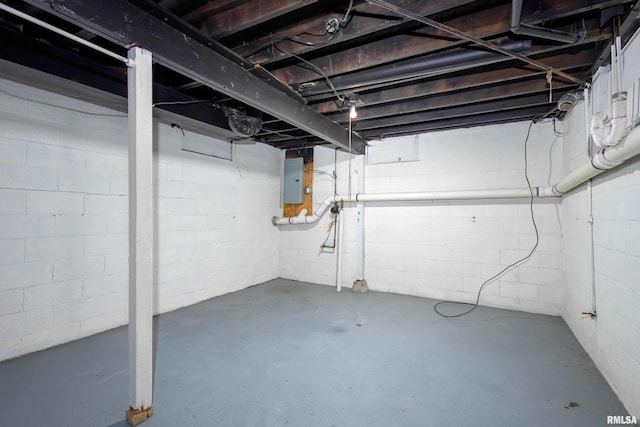 unfinished basement featuring electric panel