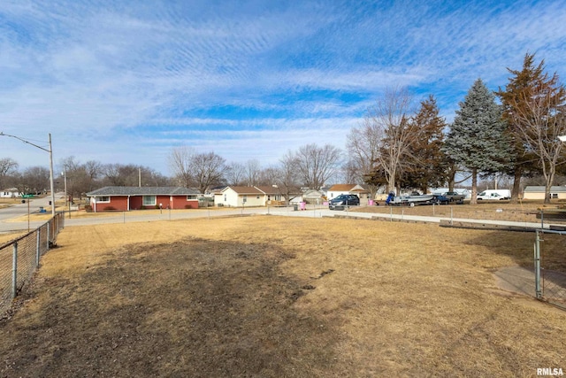 view of yard featuring a residential view and fence