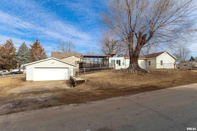 view of front facade with a garage, an outbuilding, and fence