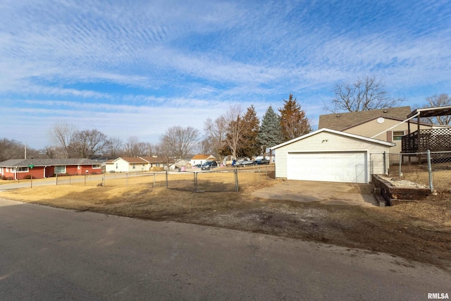 view of yard with a garage, a residential view, and fence