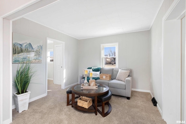 living area featuring a healthy amount of sunlight, light carpet, and crown molding