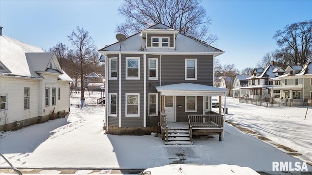 american foursquare style home featuring covered porch and a residential view