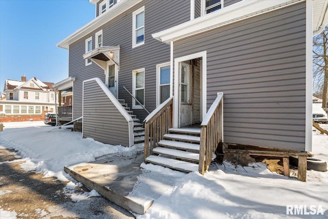 view of snow covered property entrance