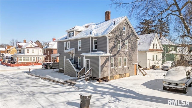 view of front of house featuring a residential view and a chimney