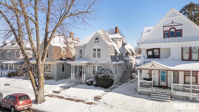 view of front of house featuring a residential view, a porch, and a gambrel roof