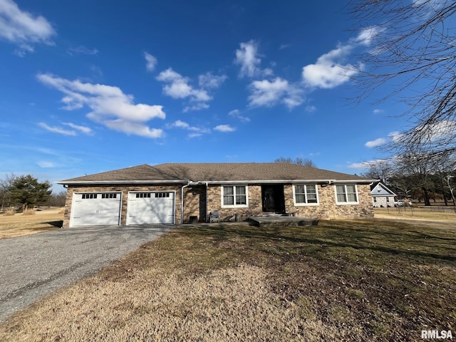 single story home with a front yard, driveway, and an attached garage