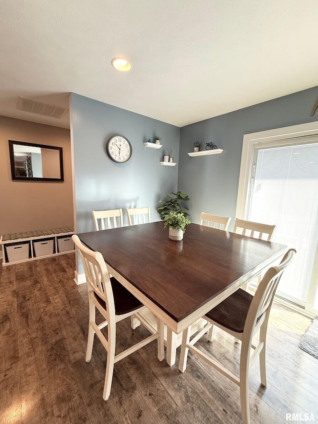 dining room with visible vents and wood finished floors